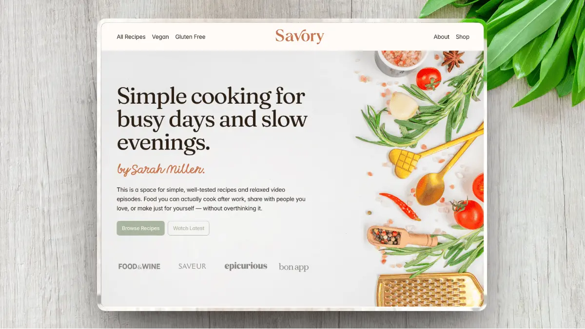 A cooking website's homepage featuring fresh ingredients and a wooden spoon. Text reads "Simple cooking for busy days and slow evenings" with a calm, inviting tone.